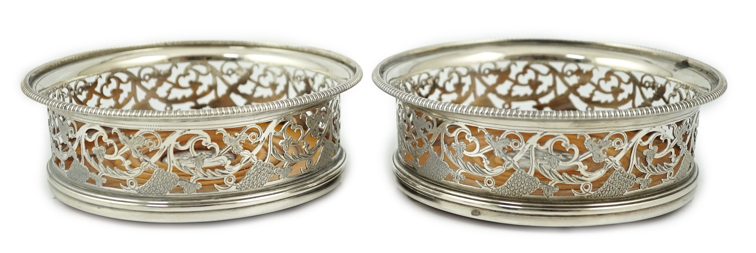 A pair of George III pierced silver mounted wine coasters, William Allen III